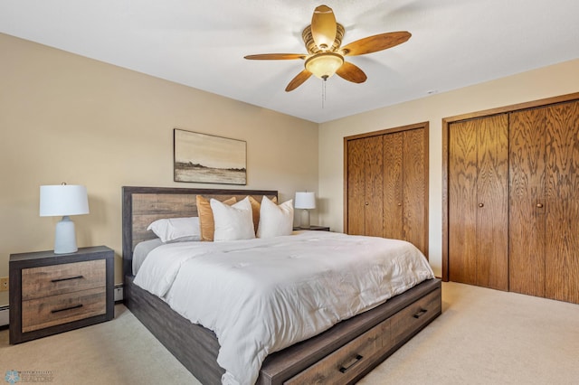 carpeted bedroom featuring multiple closets and ceiling fan