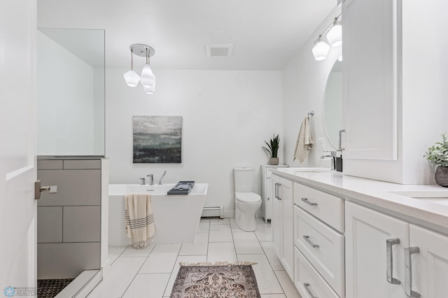 bathroom featuring vanity, toilet, tile patterned floors, and a washtub