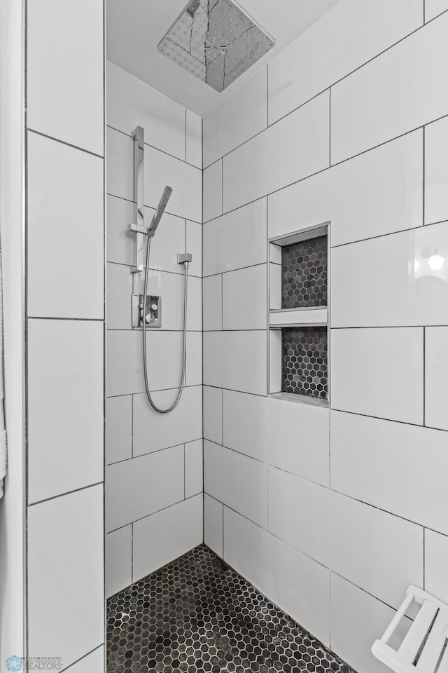 bathroom with tiled shower