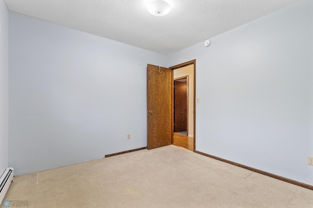 unfurnished room featuring baseboard heating, light carpet, and a textured ceiling