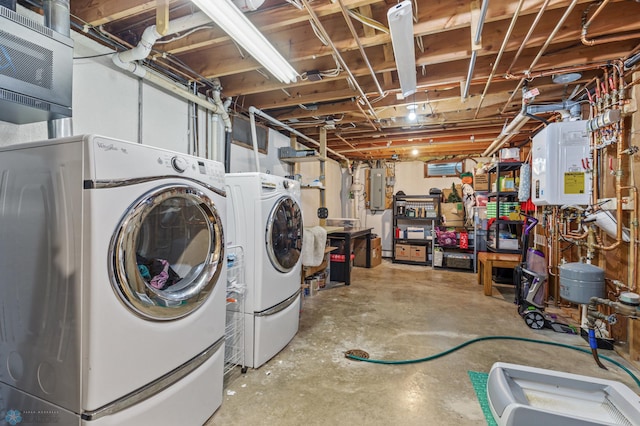 basement featuring water heater, electric panel, and separate washer and dryer