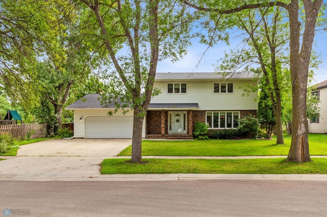 view of front facade with a garage and a front lawn