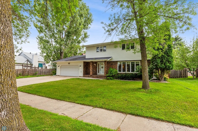 view of property featuring a front yard and a garage