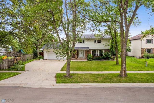 view of front of house with a front lawn and a garage