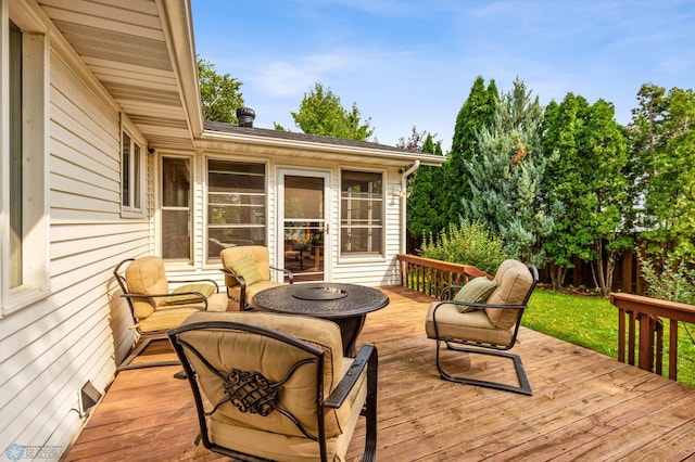 wooden terrace with an outdoor fire pit