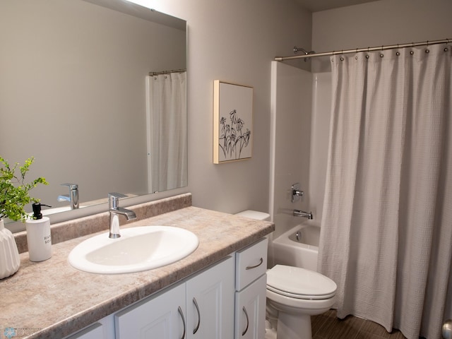 full bathroom with shower / bath combination with curtain, vanity, and toilet