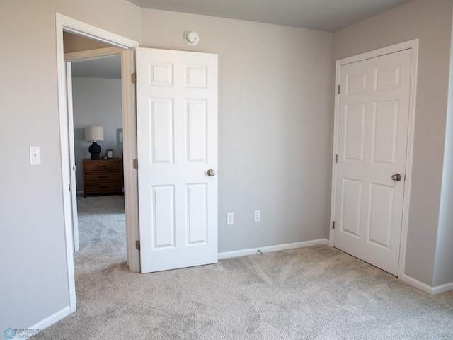 unfurnished bedroom with light colored carpet