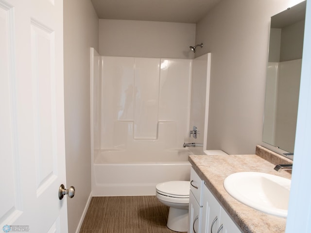 full bathroom featuring washtub / shower combination, vanity, and toilet