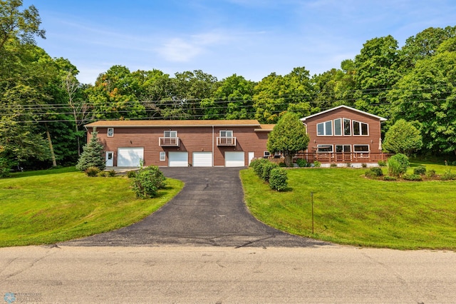 view of front of house with a garage and a front lawn