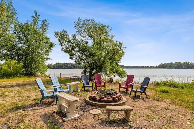 view of yard with a fire pit and a water view