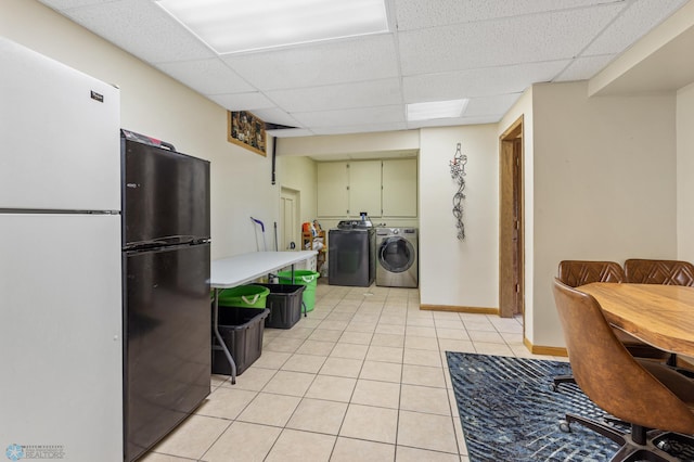 laundry area featuring washing machine and dryer and light tile patterned floors