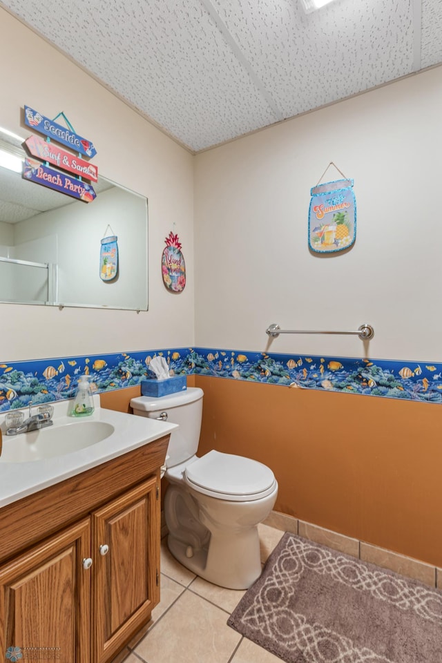 bathroom featuring tile patterned floors, toilet, and vanity