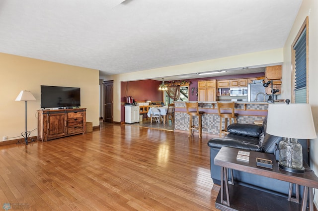 living room with hardwood / wood-style flooring and a chandelier