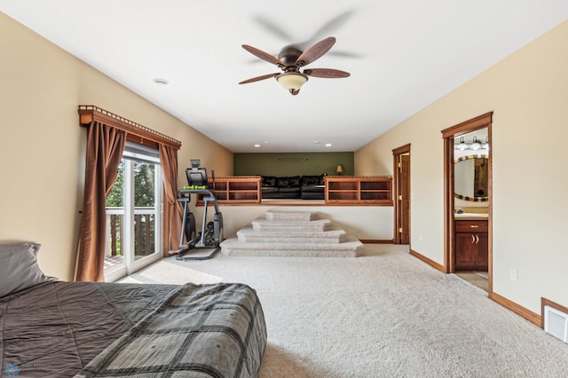 bedroom with ceiling fan, light colored carpet, ensuite bath, access to exterior, and sink