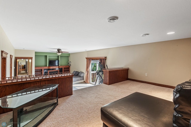 carpeted living room featuring ceiling fan