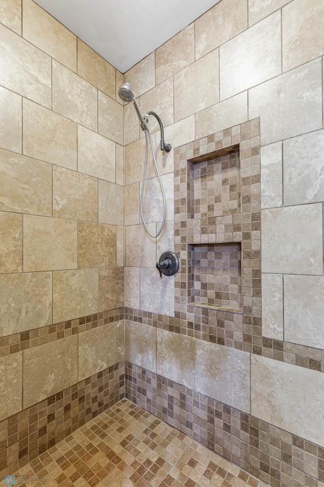 bathroom with a tile shower