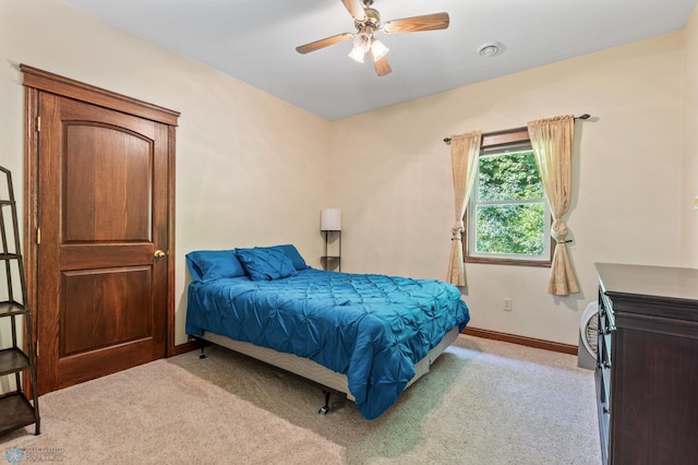 bedroom with ceiling fan and light colored carpet