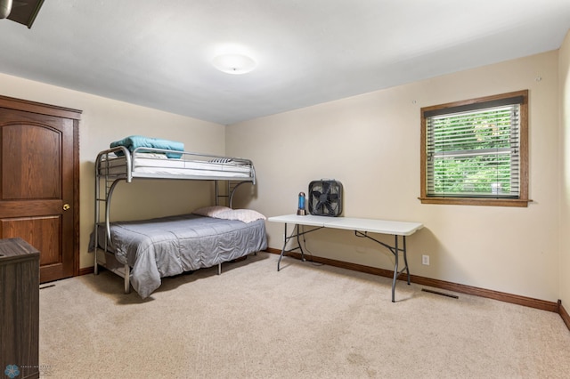 bedroom featuring light colored carpet