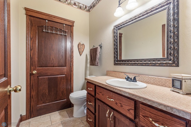 bathroom featuring tile patterned floors, toilet, and vanity