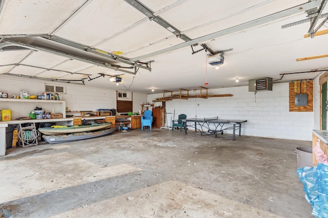 garage with a garage door opener and electric panel