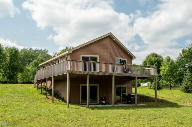 back of house with a deck and a yard