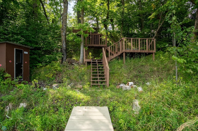 view of yard with a wooden deck and an outdoor structure