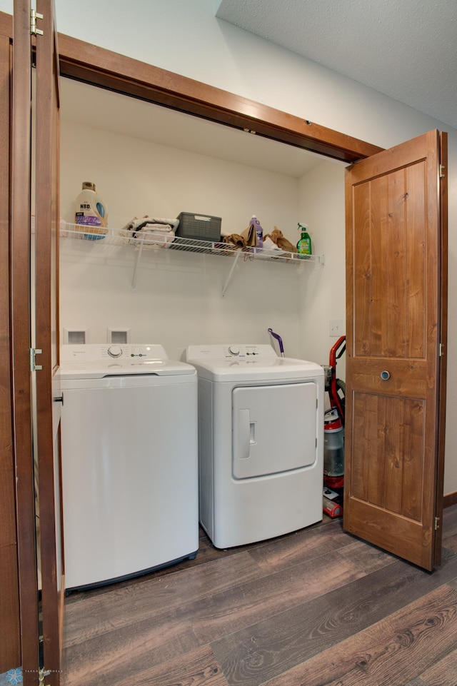 clothes washing area featuring independent washer and dryer, dark hardwood / wood-style flooring, and a textured ceiling