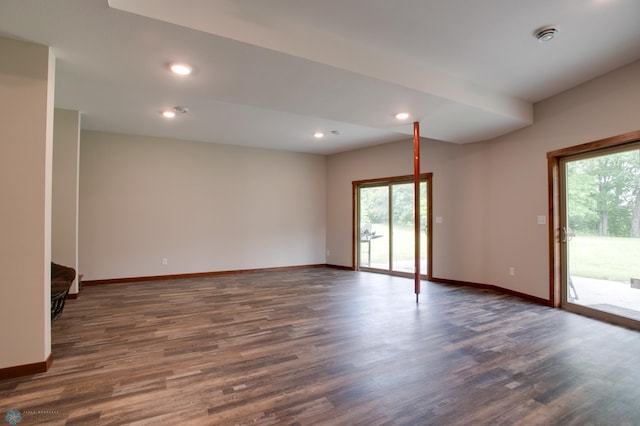 unfurnished room featuring a wealth of natural light and hardwood / wood-style floors