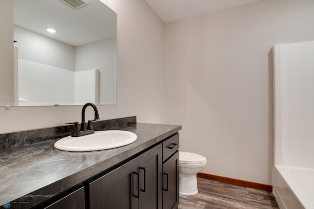 full bathroom featuring tub / shower combination, wood-type flooring, toilet, and vanity