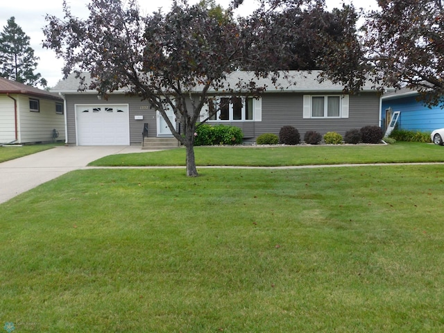 single story home with a garage and a front lawn