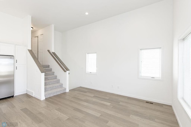 interior space featuring light wood-type flooring and a wealth of natural light