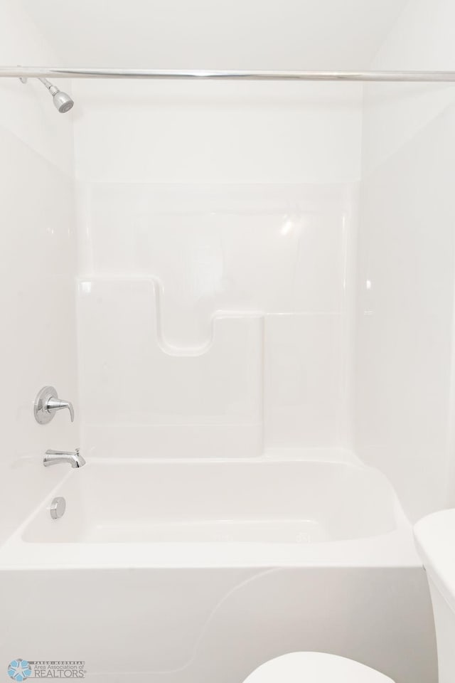 bathroom with toilet and tub / shower combination