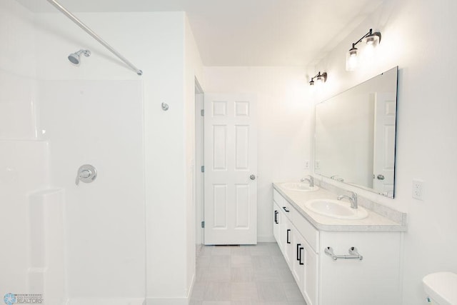 bathroom featuring vanity, toilet, walk in shower, and tile patterned flooring