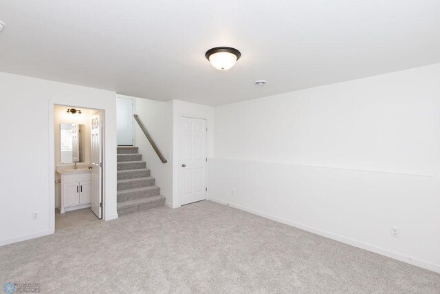 carpeted spare room featuring sink