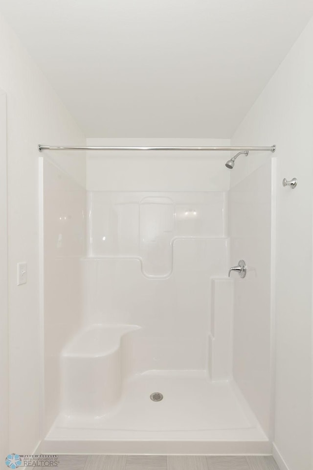 bathroom with a shower and tile patterned floors