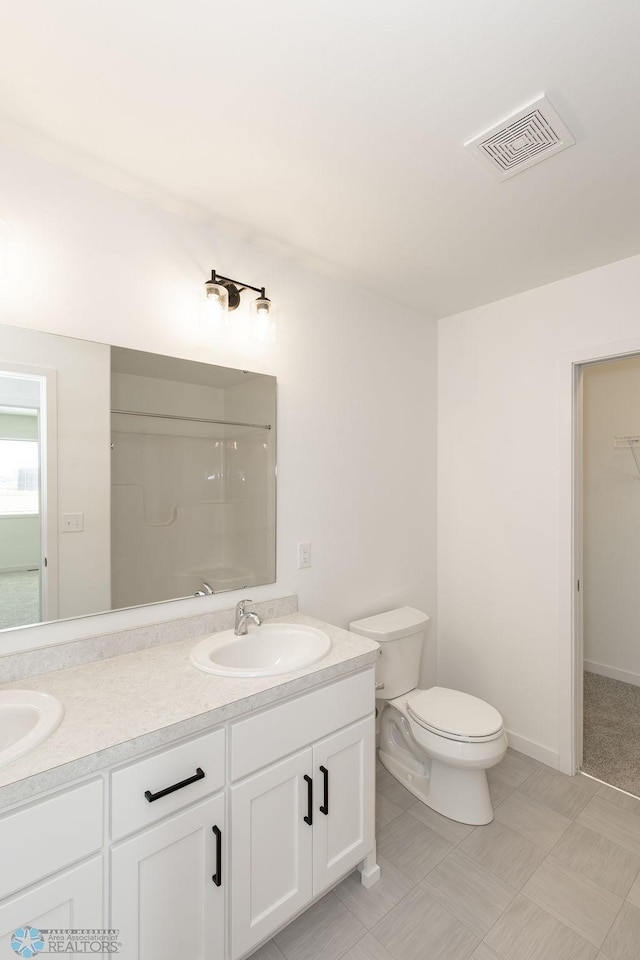 bathroom with tile patterned floors, a shower, toilet, and vanity