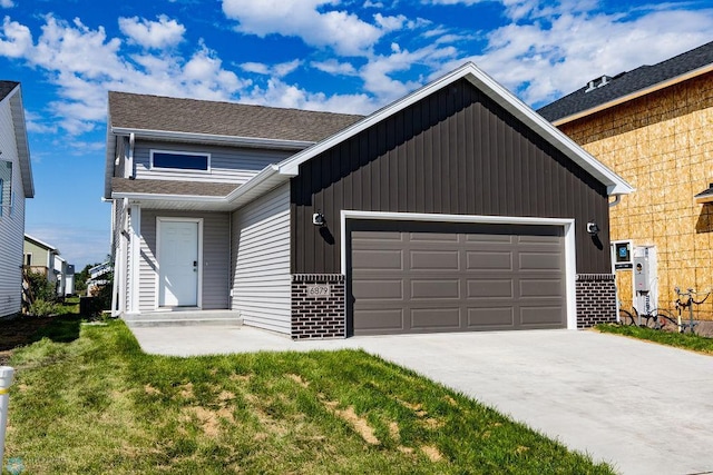 view of front of property featuring a garage and a front yard