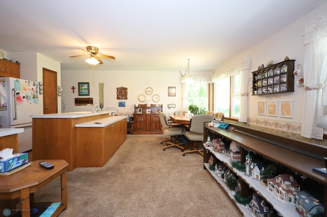 carpeted office featuring ceiling fan