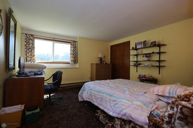 carpeted bedroom featuring a closet and a baseboard heating unit