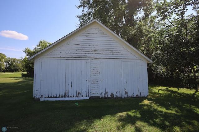 view of outbuilding with a lawn