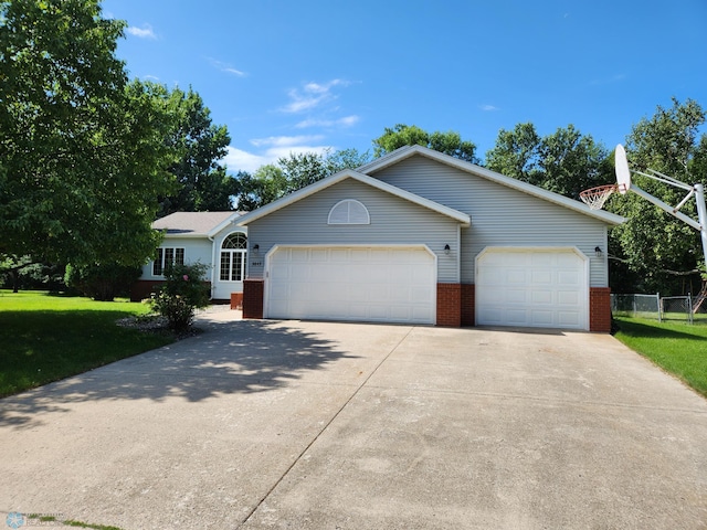 ranch-style house featuring a garage and a front yard