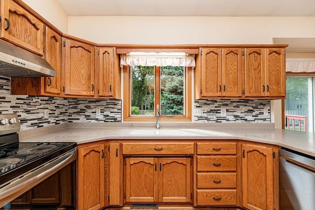 kitchen featuring stainless steel appliances, decorative backsplash, and sink