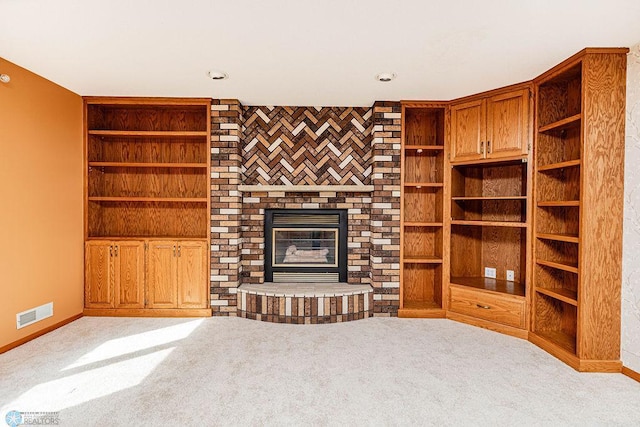 unfurnished living room featuring light carpet and a brick fireplace