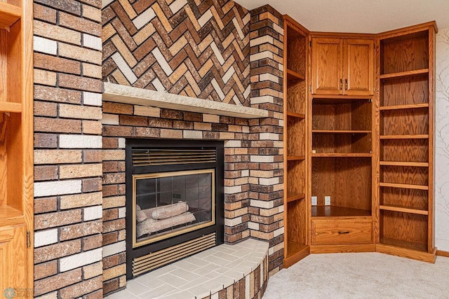 interior space with brick wall, carpet floors, and a fireplace