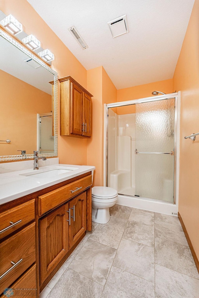 bathroom with vanity, toilet, and walk in shower