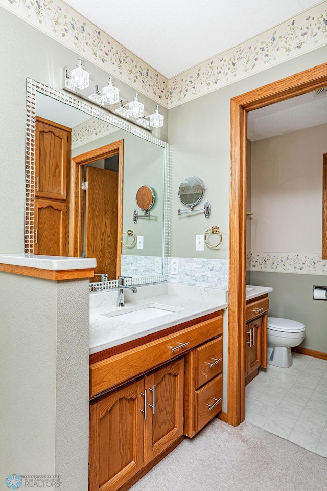 bathroom featuring vanity and toilet