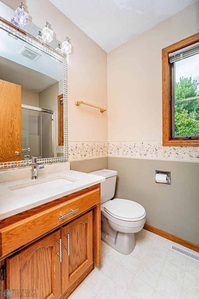 bathroom with walk in shower, toilet, a textured ceiling, and vanity