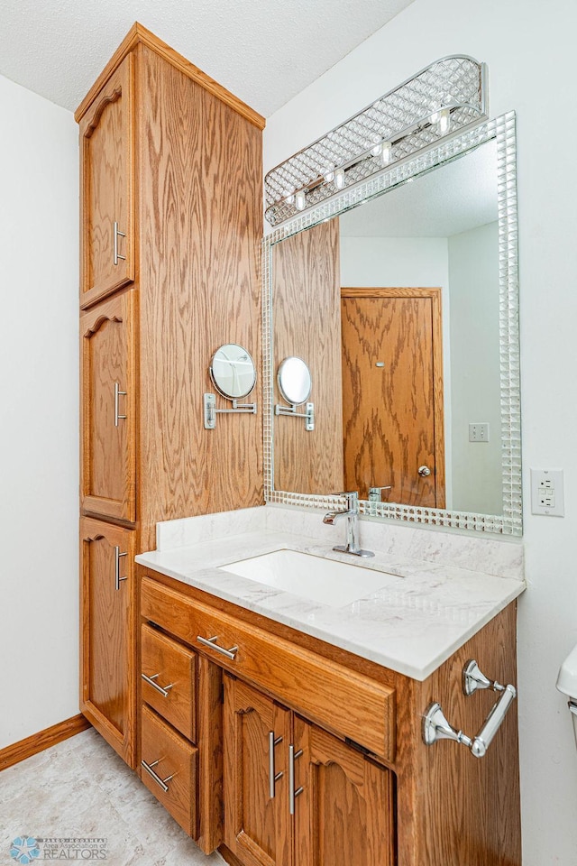 bathroom with a textured ceiling and vanity