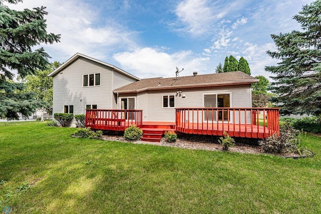 rear view of house with a lawn and a wooden deck