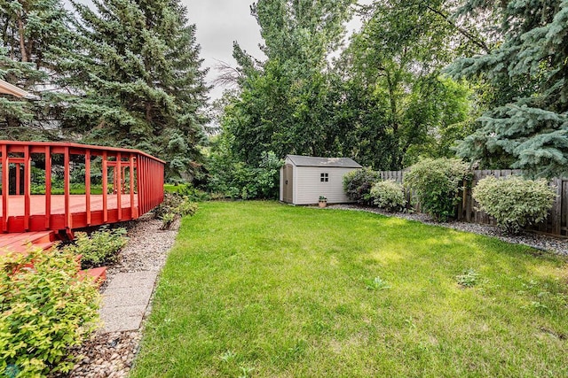 view of yard with a deck and a storage unit